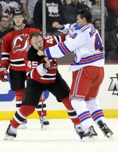 Cam Janssen and Brandon Mashinter exchange punches. AP/Bill Kostroun