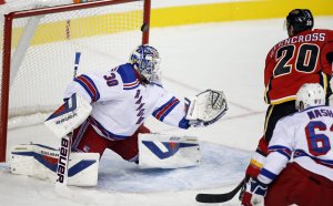 Henrik Lundqvist can't stop Curtis Glencross during the Rangers' 4-1 preseason loss at Calgary. Canadian Press/Jeff McIntosh