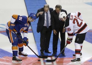 John Tavares and Patrik Elias pose for the official puck drop at Barclays Center with Bruce Ratner and Charles Wang all smiles. Julio Cortez/Associate Press