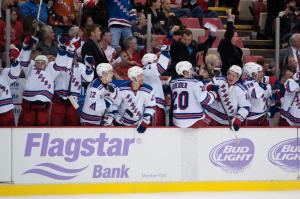 An excited Rangers bench celebrates Derick Brassard's overtime winner marking the first time they beat the Red Wings in Detroit since last century. Tim Fuller/USA Today