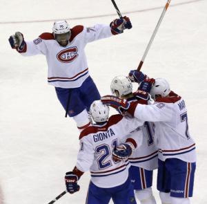 A joyous P.K. Subban thanks David Desharnais and Brian Gionta for bailing him out. AP Photo/Julio Cortez