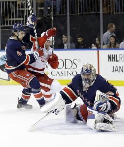 A focused Henrik Lundqvist makes a save as Mike Del Zotto battles a Red Wing in front. Getty Images/Frank Franklin II