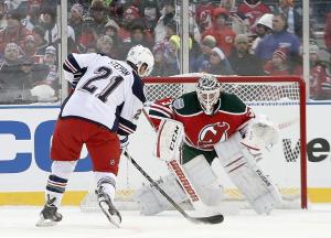 Derek Stepan goes one on one with Corey Schneider and scores on a penalty shot at Yankee Stadium. Photos by Frank Franklin II/Getty Images