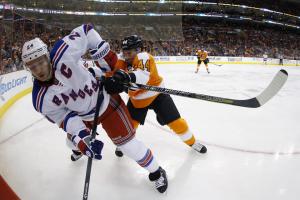 Ryan Callahan absorbs a big hit from Kimmo Timonen.  AP Photo by Matt Slocumb