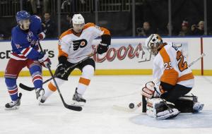 Ray Emery stops a shot with Jesper Fast searching for a rebound.  AP Photo/Kathy Willens