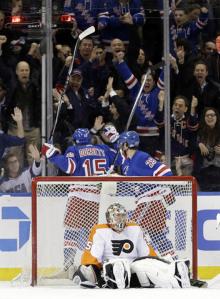 Derek Dorsett and Dominic Moore celebrate a goal on Steve Mason in a Rangers win over the Flyers. They're looking to repeat that when the teams meet in the first round later this week. AP Photo/Frank Franklin II