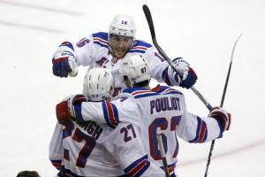 Derick Brassard celebrates a goal with teammates Benoit Pouliot and Ryan McDonagh. His overtime winner allowed the Rangers to prevail over the Penguins in Game 1 3-2. AP Photos/Gene J. Puskar