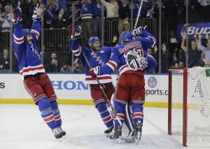 Jubilation at MSG: Excited Rangers celebrate with Henrik Lundqvist after advancing to the Stanley Cup Finals. AP Photo/Julia Jacobson