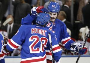 Dominic Moore is congratulated by Brian Boyle after his series clinching goal in the second period. AP Photo/Kathy Willens