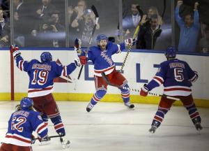 Overtime hero Martin St. Louis raises his arms as Brad Richards and Dan Girardi greet him. AP Photo/Seth Wenig
