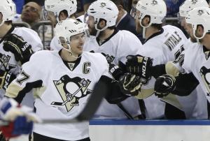 No Kidding: Sidney Crosby is congratulated by teammates at the Pens bench after scoring in their 2-0 Game 3 win over the Rangers.  AP Photo/Kathy Willens