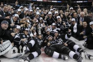 The 2013-14 Stanley Cup champion Los Angeles Kings pose for a photo with the Cup.  AP Photo/Jae C. Hong