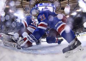 Stepan To The Rescue: Derek Stepan makes the save of the game tucking the puck under Henrik Lundqvist.  AP Photo/Bruce Bennett