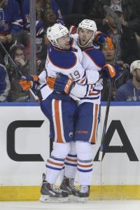 Welcome Back Benoit: Oiler goalscorer Benoit Pouliot celebrates his game-winner with teammate Justin Schultz.  Getty Images/AP Photo by John Minchillo