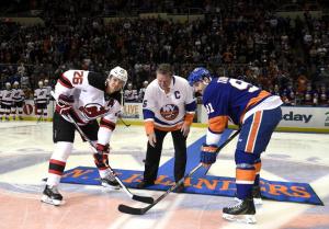 Denis Potvin drops the puck between Patrik Elias and John Tavares. Kathy Kmonicek/AP Photo Getty Images