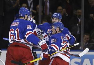 Marty St. Louis celebrates his goal with Rick Nash and Marc Staal. AP Photo by Frank Franklin II/Getty Images