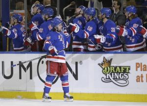 Mats Zuccarello gets congrats at the bench following his goal in the first period. AP Photo by Frank Franklin II/Getty Images