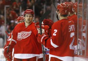Darren Helm gets congrats from Brendan Smith after scoring the game-winner in Detroit's 3-2 win over the Rangers. AP Photo by Paul Sancya/Getty Images