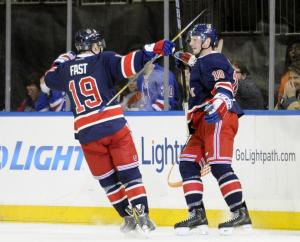 The Kids Are Alright: Jesper Fast congratulates J.T. Miller on his goal during the Rangers' 5-2 win over the Flyers.  AP Photo by Bill Kostroun/Getty Images
