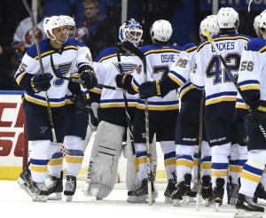 Marty The Blue: An unfamiliar sight as Martin Brodeur is congratulated by his new Blues teammates following his win in relief for number 689. AP Photo by Kathy Kmonicek/Getty Images