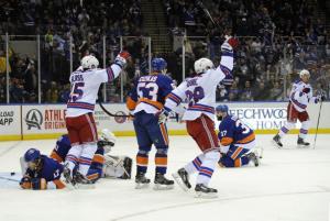 Ryan McDonagh (far side) scores the first of two with Tanner Glass and Dominic Moore screening in front. The Rangers rallied to defeat the Islanders 6-5 in a wild game. AP Photo by Kathy Kmonicek/Getty Images