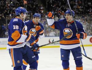 Ryan Strome celebrates a goal with teammates Brock Nelson and Travis Hamonic. AP Photo by Kathy Kmonicek/Getty Images