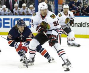 Brad Richards is checked by ex-teammate Carl Hagelin. Richards had a successful return scoring the only goal in the Hawks' 1-0 shutout over the Rangers. AP Photo by Frank Franklin II/Getty Images