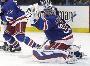 Henrik Lundqvist makes a glove save in Game 1 against the Pens. He finished with 24 saves in the Rangers' 2-1 win. AP Photo by Frank Franklin II/Getty Images