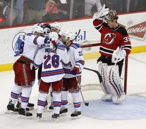 Sheppard's Pie: Rangers' goalscorer James Sheppard is congratulated by Dominic Moore and Dan Boyle.  AP Photo by Julio Cortez/Getty Images