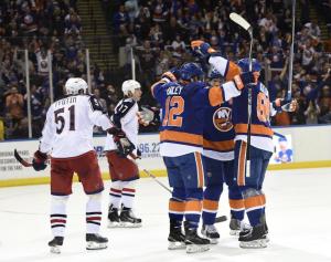 Kyle Okposo celebrates his goal with teammates Josh Bailey and Nikolay Kulemin. AP Photo by Kathy Kmonicek/Getty Images