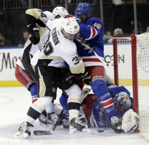 Close Call: The Pens nearly tie it but Marc Staal denies the opportunity in front of Henrik Lundqvist who made the big save on Evgeni Malkin in the second period. AP Photo by Frank Franklin II/Getty Images