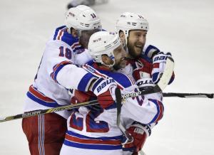 Dan Boyle is congratulated by Marc Staal and Tanner Glass following his big goal that proved to be the winner in the Rangers' hair raising 4-3 win over the Caps to take Game 6. AP Photo by Nick Wass/Getty Images