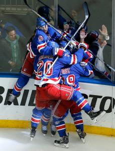 The New York Rangers celebrate their game winning overtime goal against the Washington Capitals in Game 7 of the Eastern Conference semifinals during the NHL hockey Stanley Cup playoffs, Wednesday, May 13, 2015, in New York. (AP Photo/Julie Jacobson)