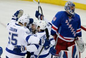 Johnson Hat Trick: Tyler Johnson is mobbed by teammates after scoring a hat trick in the Lightning's 6-2 win over the Rangers in Game 2. AP Photo by Frank Franklin II/Getty Images