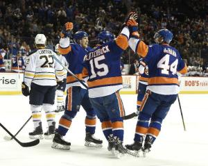Islanders defenseman Calvin de Haan is congratulated by Cal Clutterbuck after scoring against the Sabres. The Isles lost 2-1. AP Photo by Kathy Kmonicek/Getty Images