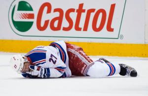 New York Rangers defenseman Ryan McDonagh (27) lies injured on the ice after taking a hit to the head from Toronto Maple Leafs center Leo Komarov during the first period of an NHL hockey game Thursday, Feb. 18, 2016, in Toronto. (Nathan Denette/The Canadian Press. via AP)